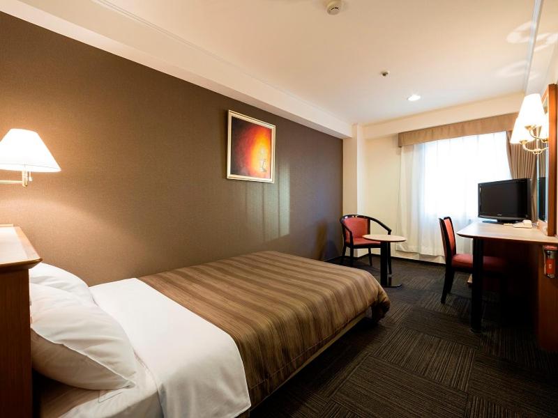 Postel nebo postele na pokoji v ubytování Ark Hotel Osaka Shinsaibashi -ROUTE INN HOTELS-