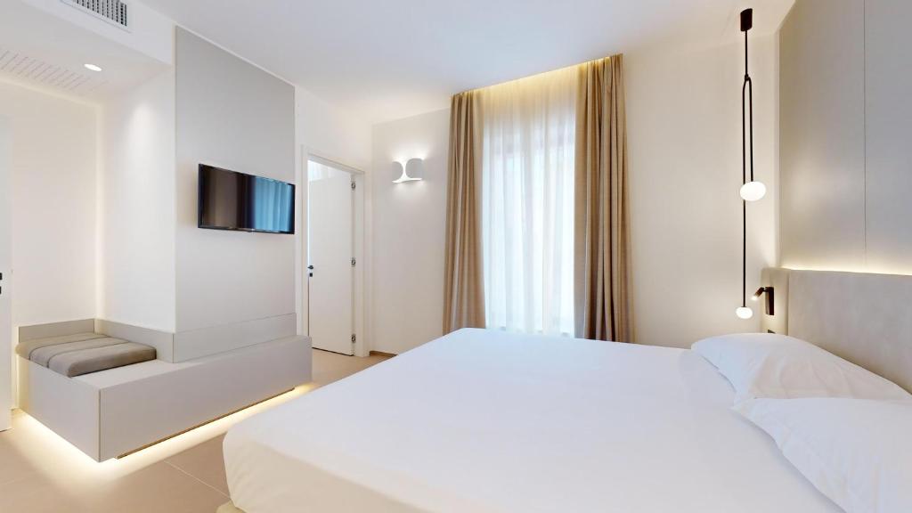 Postel nebo postele na pokoji v ubytování PRIMO OSTUNI HOTEL