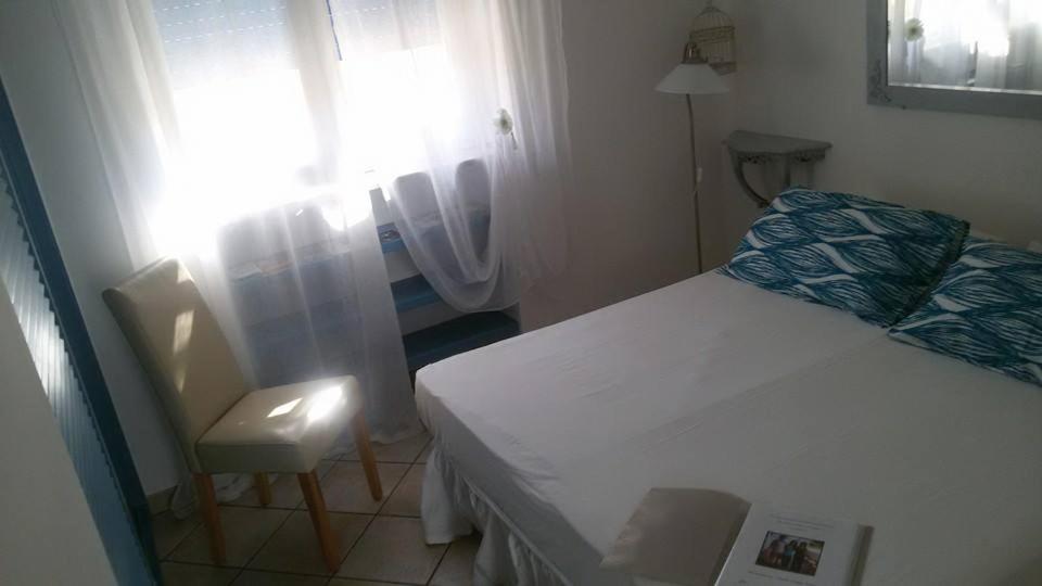 A bed or beds in a room at La Caletta Bed and Breakfast