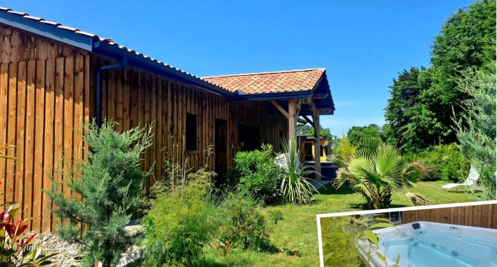 une maison avec un bain à remous dans la cour dans l'établissement Les Bord'Océanes Sauna & Spa Villa Marensine et Villa Oyat, à Vielle-Saint-Girons
