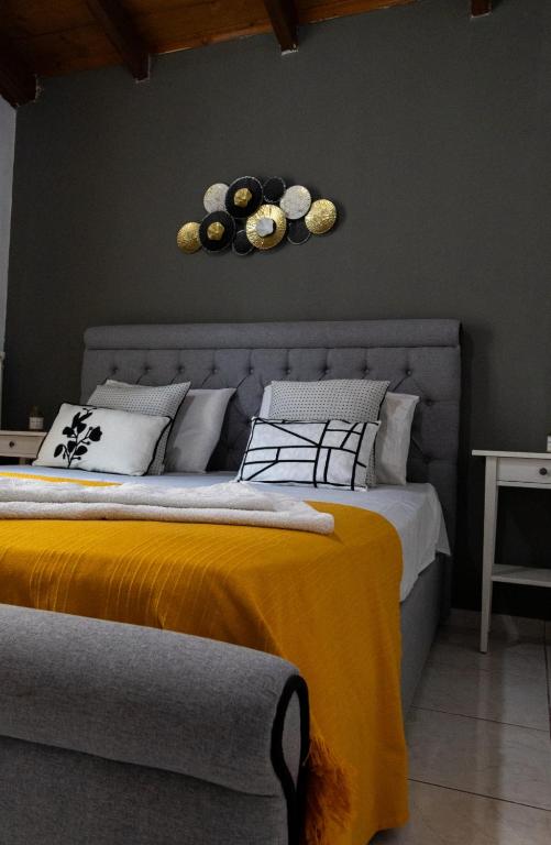a bedroom with a bed with a yellow blanket at Evelina 5 in Lixouri
