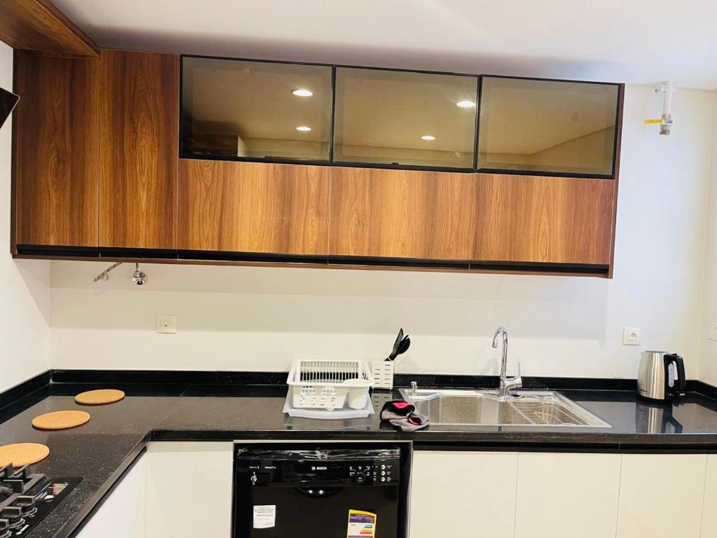 a kitchen with a sink and a counter top at Mivida Emaar New Cairo For Rent in New cairo