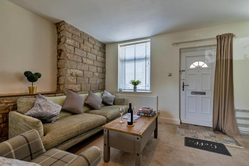 ein Wohnzimmer mit Sofa und Tisch in der Unterkunft Finest Retreats - Suzys Cottage in Disley
