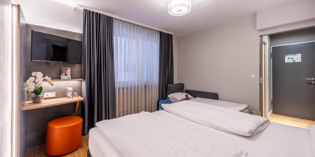 Katil atau katil-katil dalam bilik di PLAZA INN Rieker Stuttgart Hauptbahnhof
