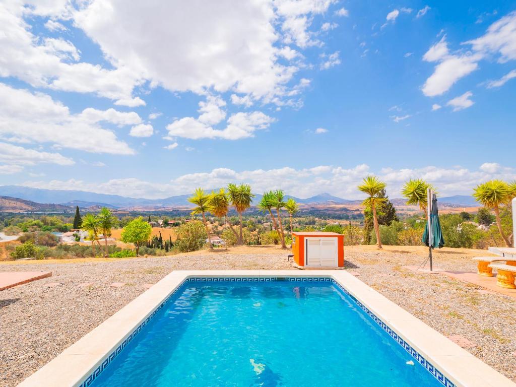 a swimming pool with a view of the mountains at Cubo's Casa Rural El Andaluz in Villafranco de Guadalhorce