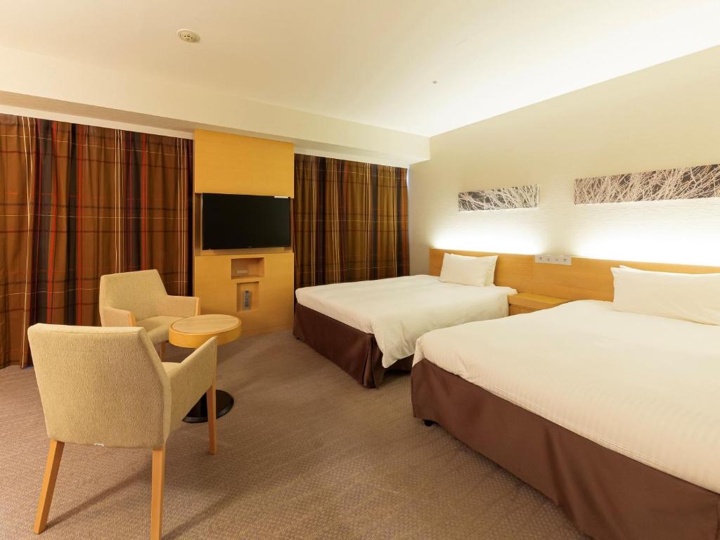 Postel nebo postele na pokoji v ubytování Hotel Keihan Kyobashi Grande
