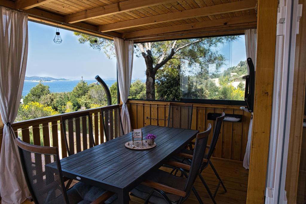 a wooden table on a deck with a view at Mobilehome Palema 16 in Drage
