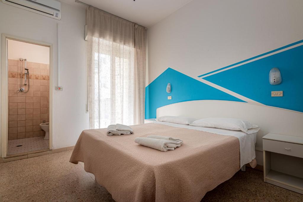 Postel nebo postele na pokoji v ubytování Hotel Serafini