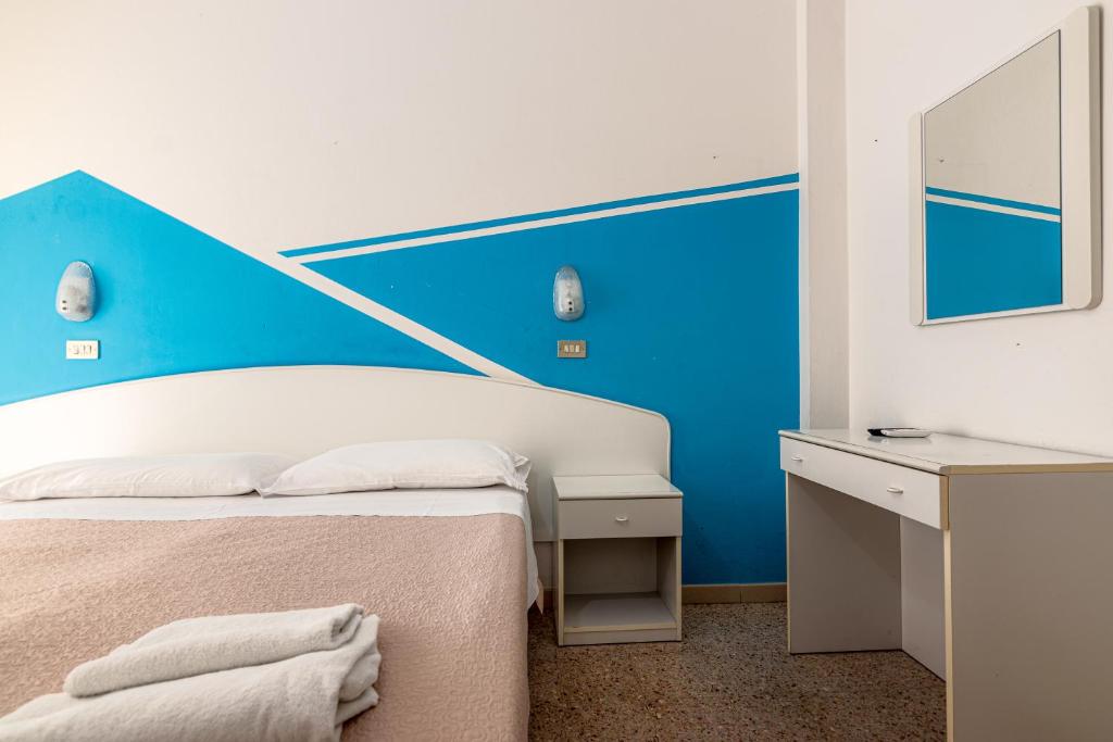 Postel nebo postele na pokoji v ubytování Hotel Serafini