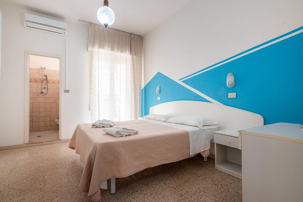 Postel nebo postele na pokoji v ubytování Hotel Serafini