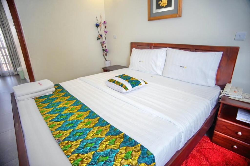 Postel nebo postele na pokoji v ubytování Kenendia Hotel