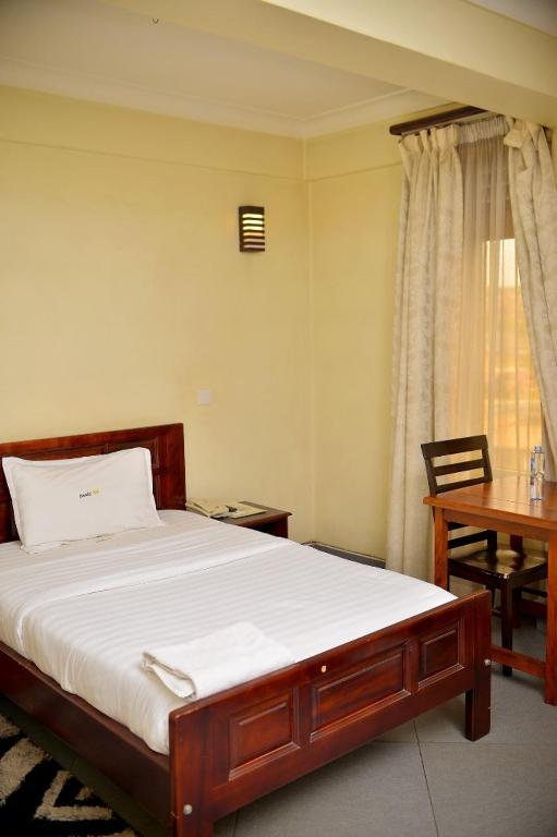 Postel nebo postele na pokoji v ubytování Kenendia Hotel