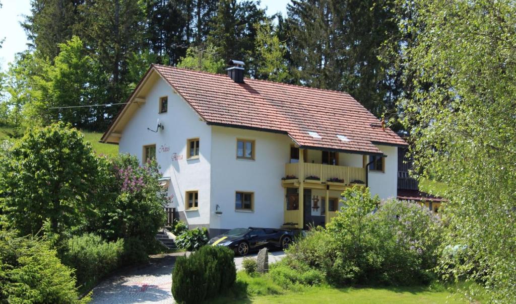 a white house with a red roof at Haus Anna Königsdorfer in Neureichenau