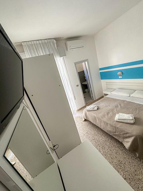 Postel nebo postele na pokoji v ubytování Hotel Serafini