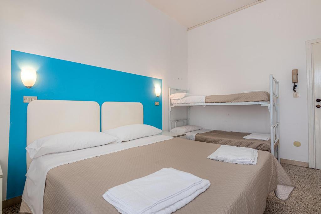 Postel nebo postele na pokoji v ubytování Hotel Serafini