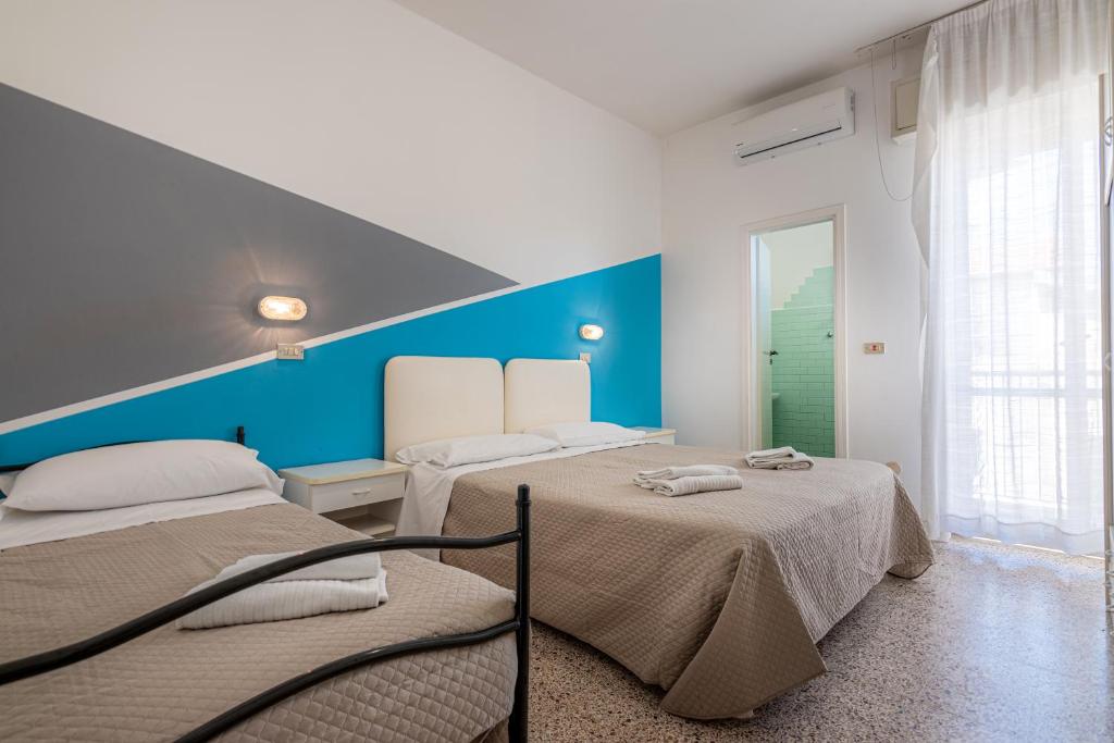 Postel nebo postele na pokoji v ubytování Hotel Serafini