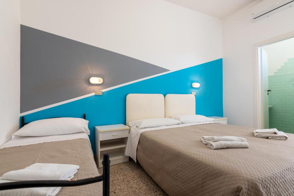 Postel nebo postele na pokoji v ubytování Hotel Serafini