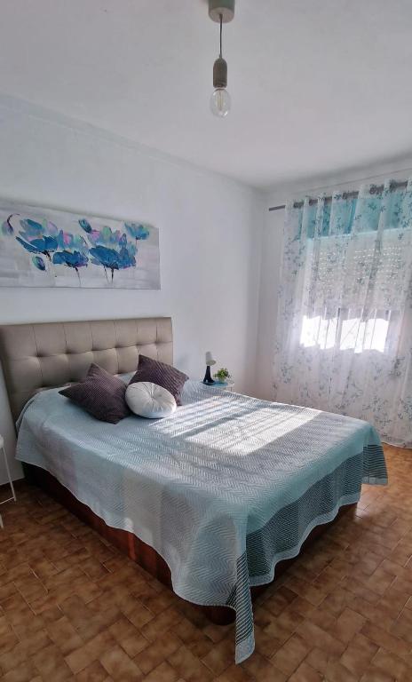 a bedroom with a large bed with a blue blanket at Casa 33 in Lagos