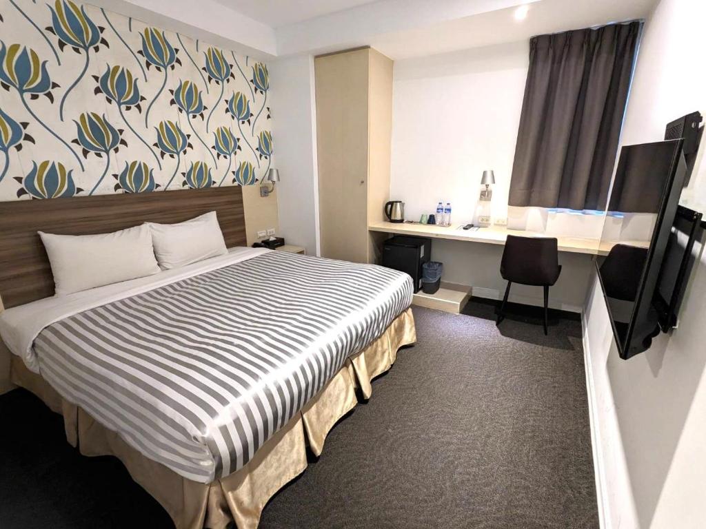 Postel nebo postele na pokoji v ubytování Ximen Hotel