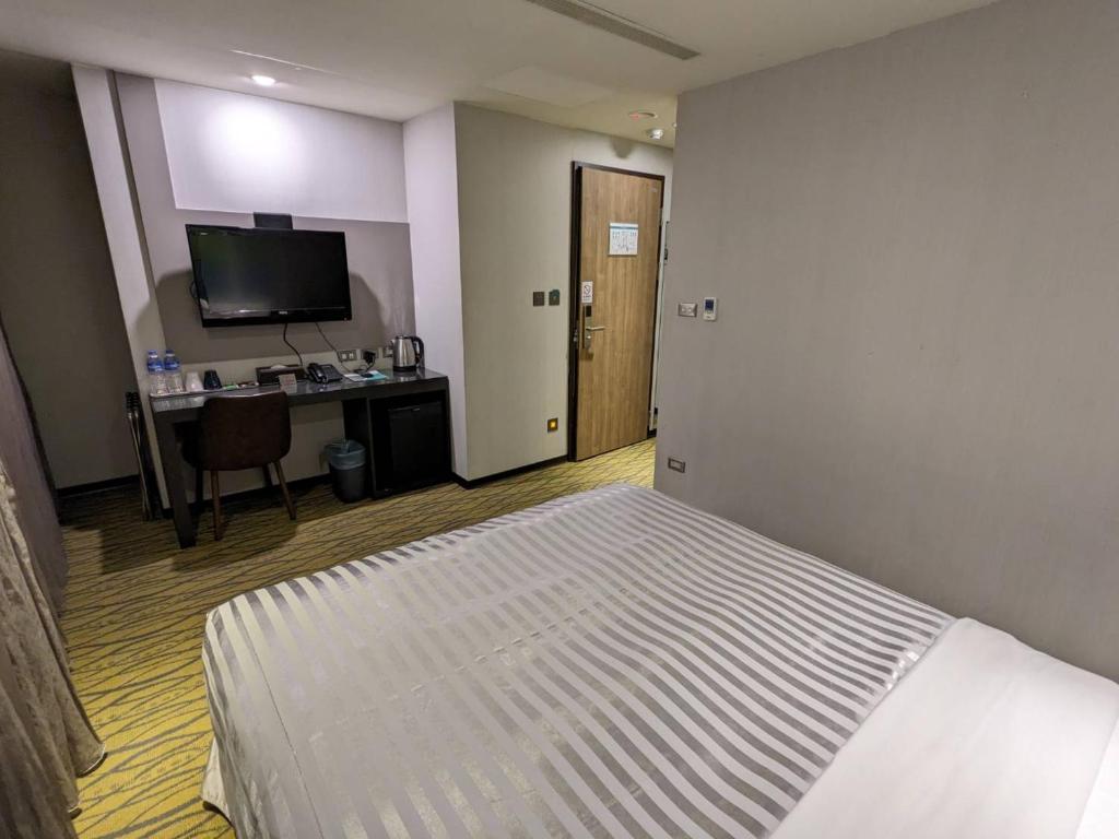 Postel nebo postele na pokoji v ubytování Ximen Hotel B