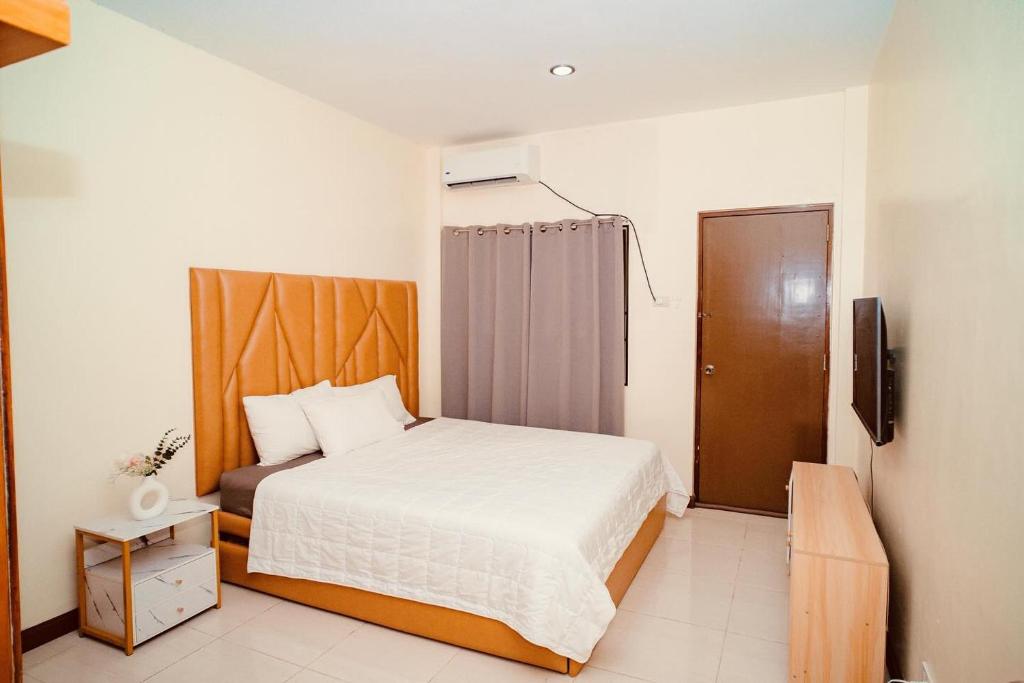 a small bedroom with a bed and a television at Le Ans Haven fully-furnished homestay in Puerto Princesa City