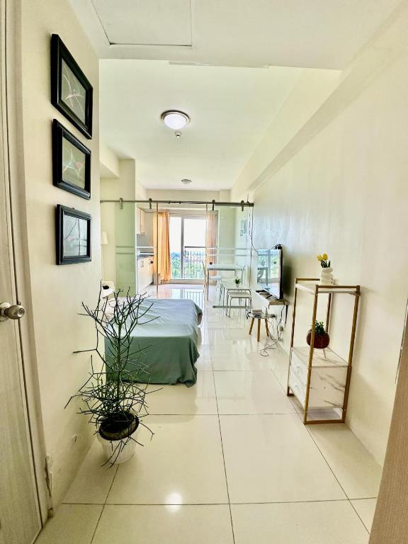 a living room with a bed and a table at La Cassandra at SMDC Wind Residences Tower 2 - Tagaytay City in Tagaytay