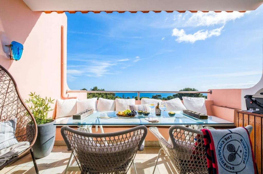 a balcony with a table and chairs and a view of the ocean at Luxury Sea View in Cascais