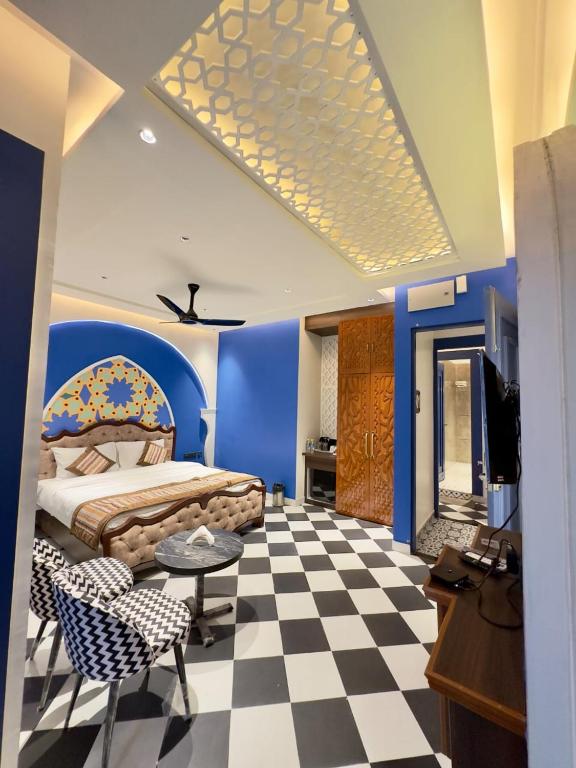 a bedroom with a bed and a checkered floor at Hotel Grand Kailash Haveli in Kotdwāra