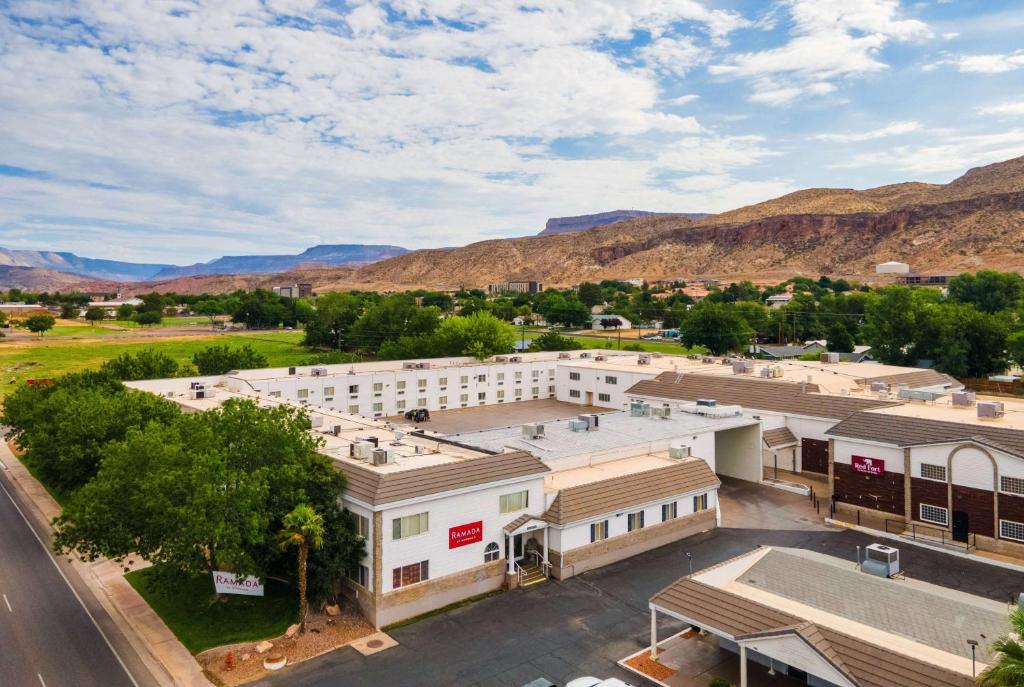 an aerial view of a building with mountains in the background at Ramada by Wyndham La Verkin Zion National Park in La Verkin