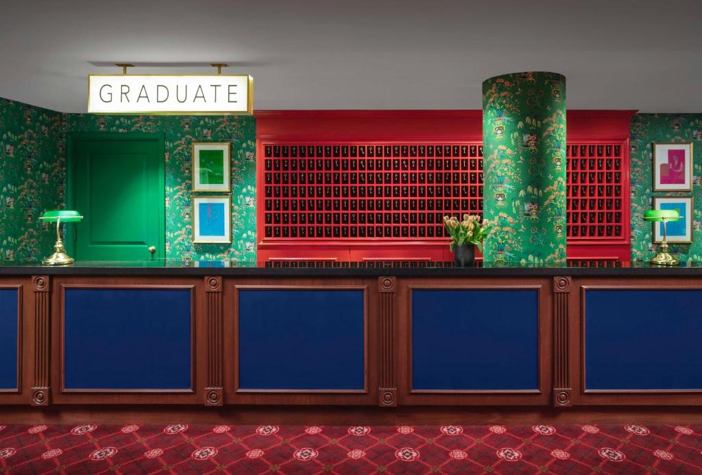 a lobby with a counter with blue and green at Graduate by Hilton Providence in Providence
