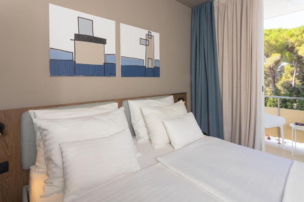 Postel nebo postele na pokoji v ubytování Family Hotel Adria - All inclusive