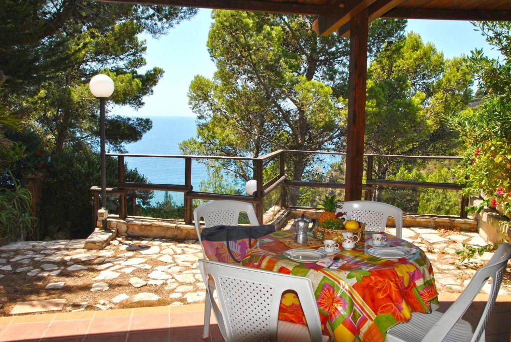 a table and chairs on a patio with a view of the ocean at Casa Marilena vista mare in Sperlonga