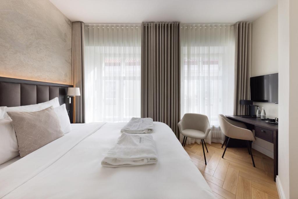 Postel nebo postele na pokoji v ubytování Nunne Boutique Hotel