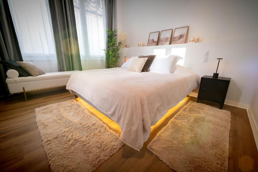a bedroom with a large bed with white sheets and pillows at Riviera Bliss in Nice