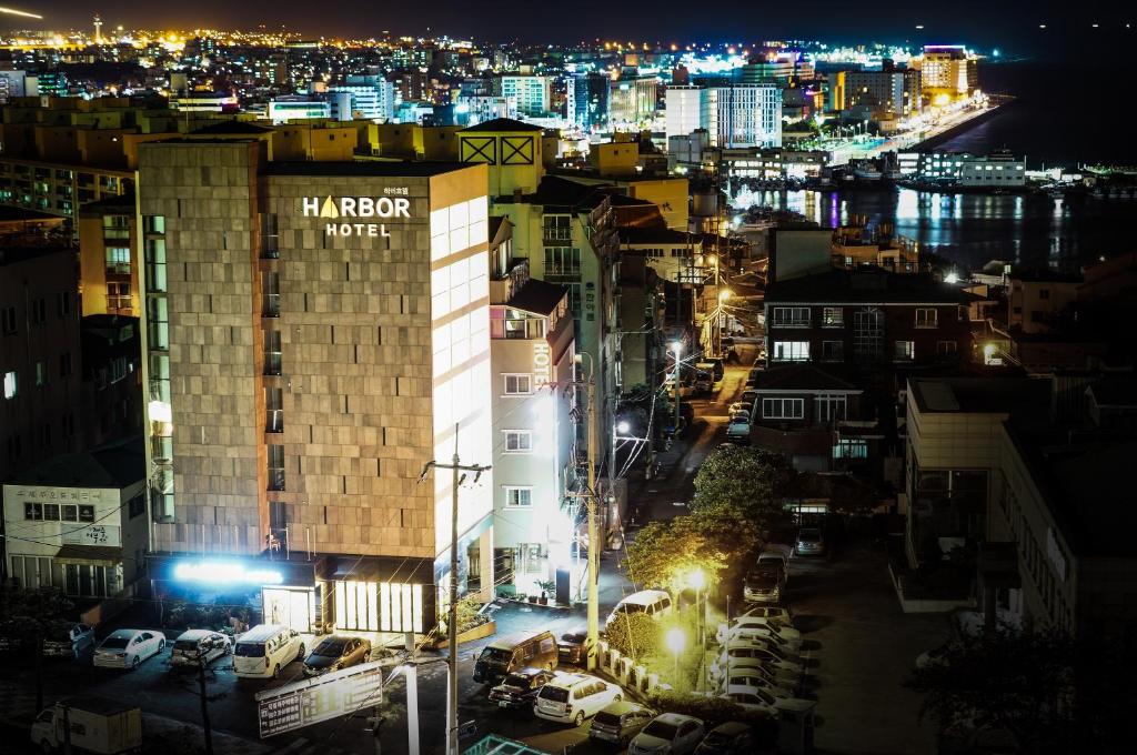 a view of a city at night with a hotel at Harbor Hotel in Jeju