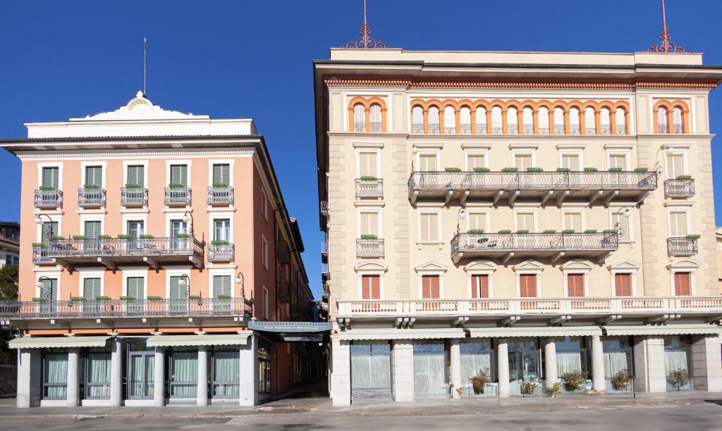 two buildings next to each other on a street at Hotel Belvedere San Gottardo in Verbania