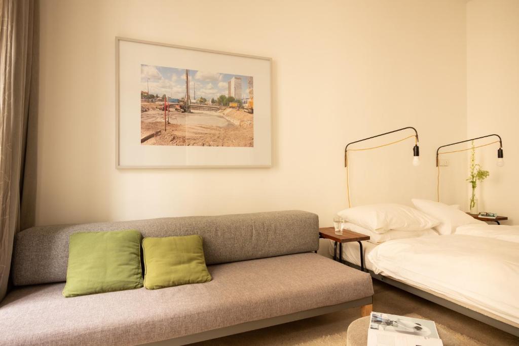 a living room with a couch and a bed at Miniloft Apartment Hotel in Berlin
