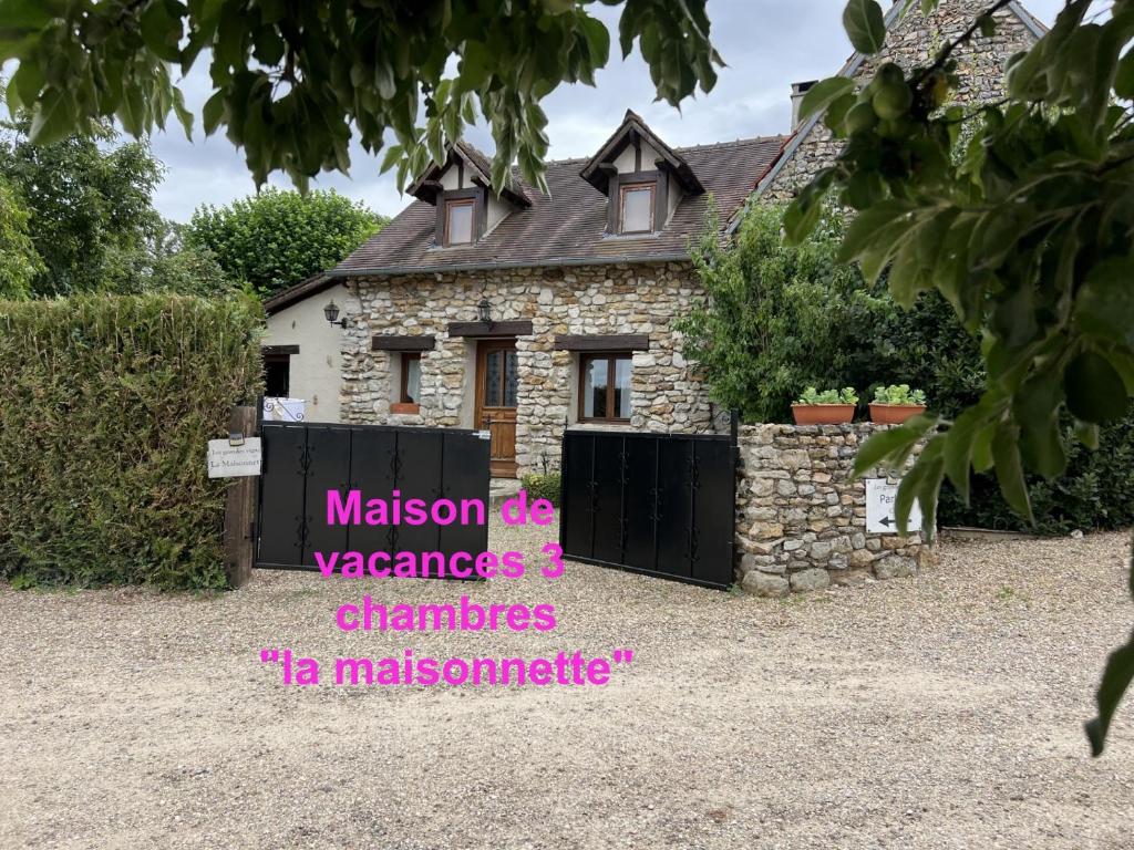 a stone house with a sign in front of it at 3 Gites au grande Vigne in Saint-Étienne-sous-Bailleul