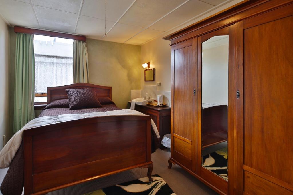 Postel nebo postele na pokoji v ubytování Astor Private Hotel