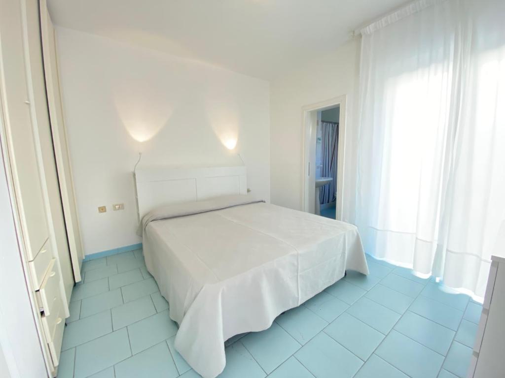 Postel nebo postele na pokoji v ubytování Hotel Lorenza B&B e Mini Suite