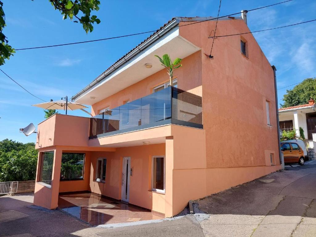 a building with a palm tree on the side of it at La Dama in Novi Vinodolski