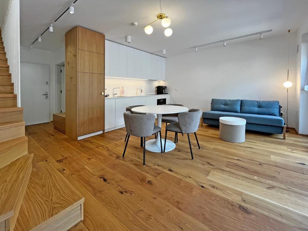 a kitchen and a living room with a table and chairs at Apartma 17 - Perla in Bovec