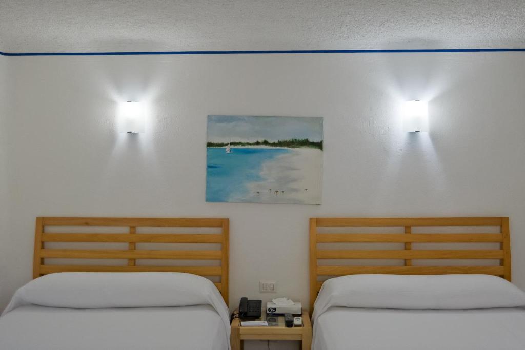 Postel nebo postele na pokoji v ubytování Sotavento Hotel & Yacht Club