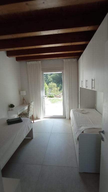 Postel nebo postele na pokoji v ubytování Agriturismo Casa Bregalda
