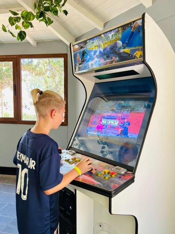 a young girl playing a video game in a video game arcade at Marhaba Royal Salem - Family Only in Sousse