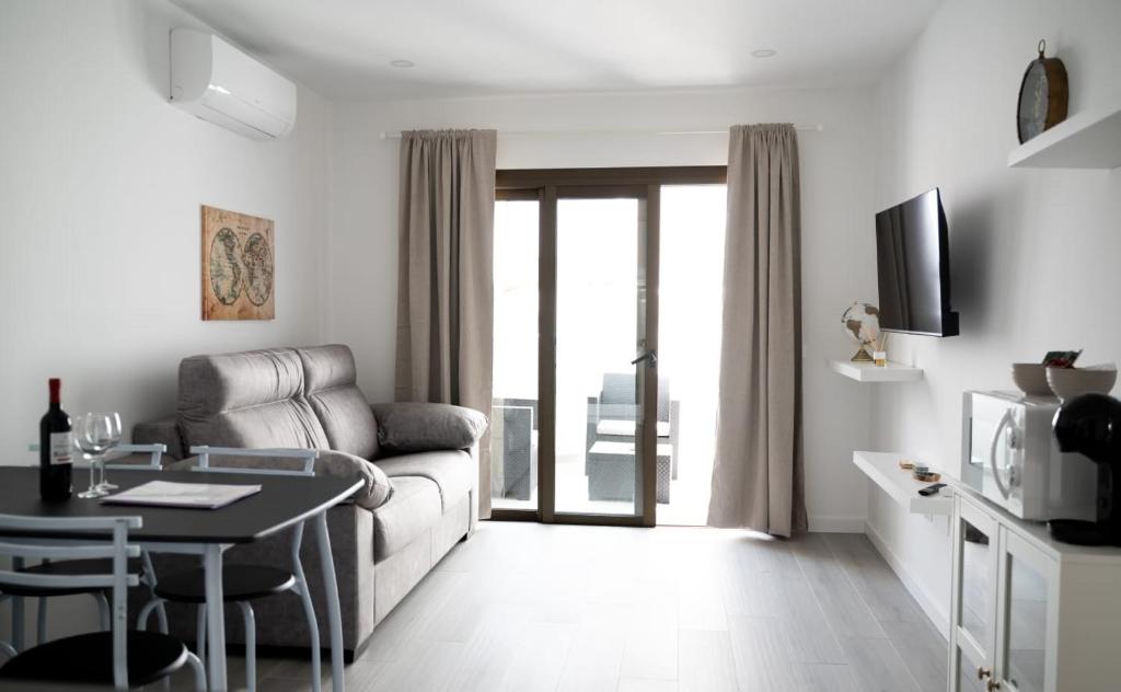 a living room with a couch and a table at Los Cristianos Aqua Viva in Los Cristianos