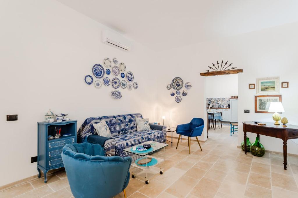 un soggiorno con un divano blu e un tavolo di Albachiara Home ad Andria