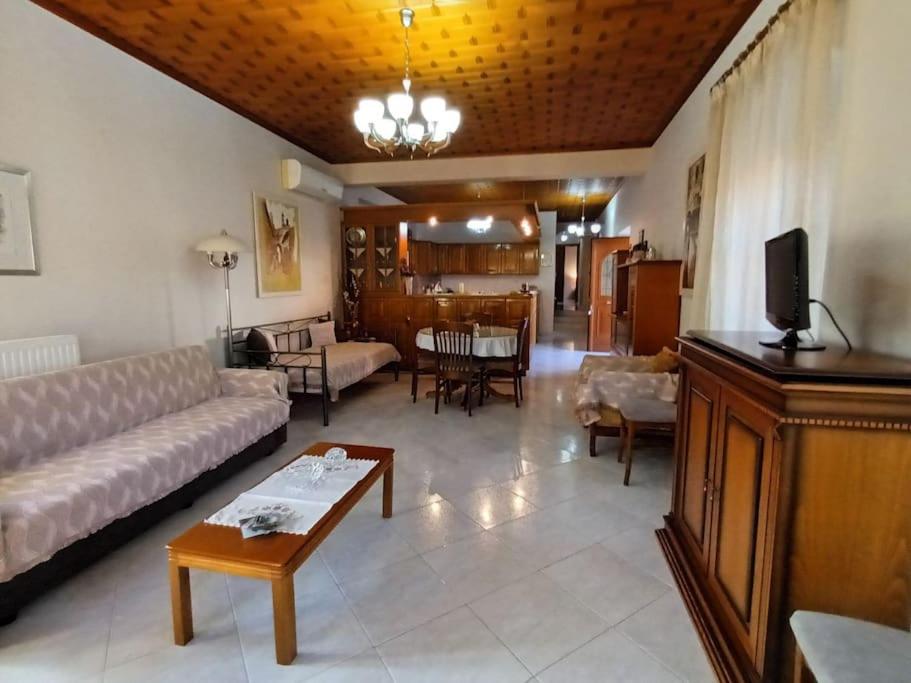 a living room with a couch and a table at MetaxiasAndMariasHouse in Leonidion