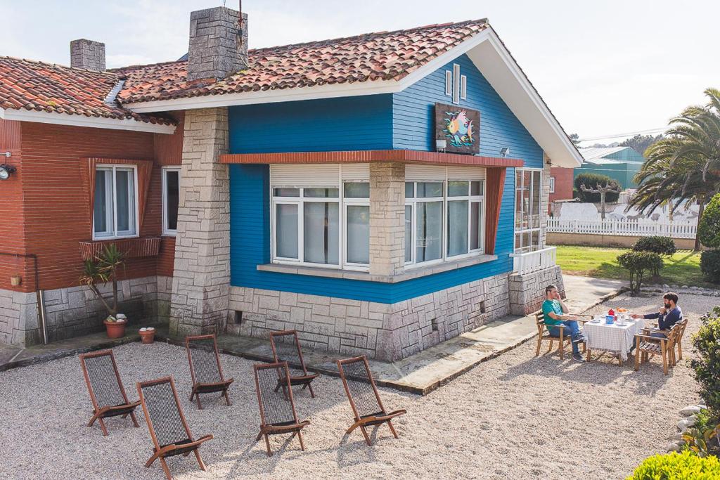 two people sitting at a table outside of a house at El Pez Escorpion in Salinas