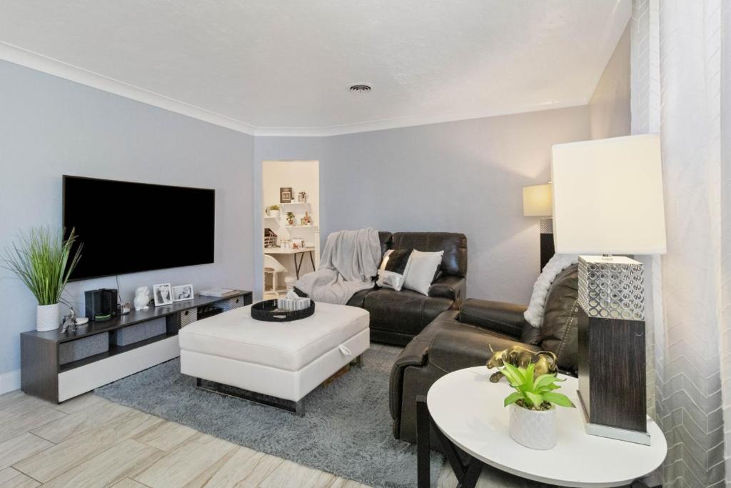 a living room with a couch and a tv at 6 BR Pool Family Getaway near Coquina Beach in Bradenton